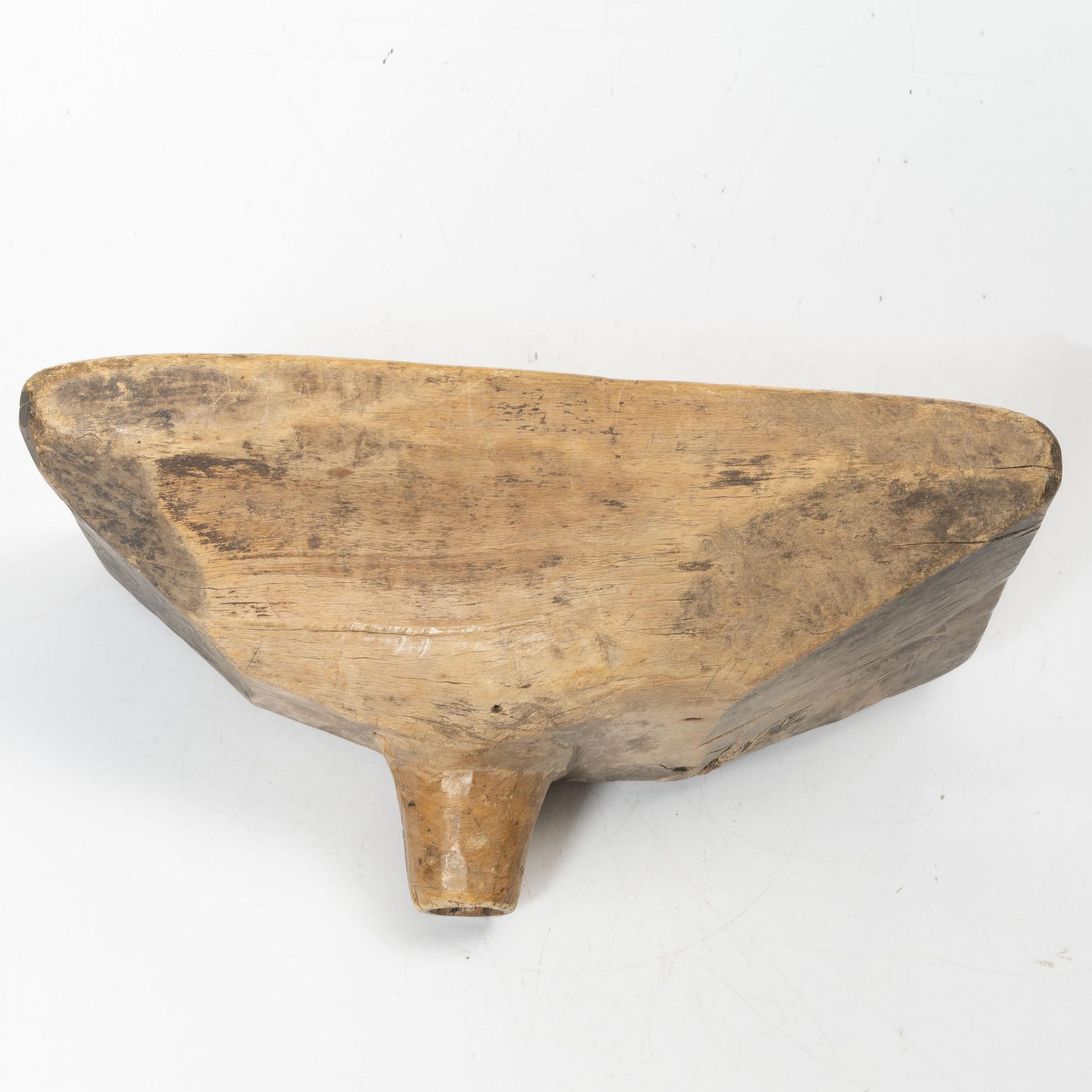 A Swedish carved wood milk funnel, dated 1687.