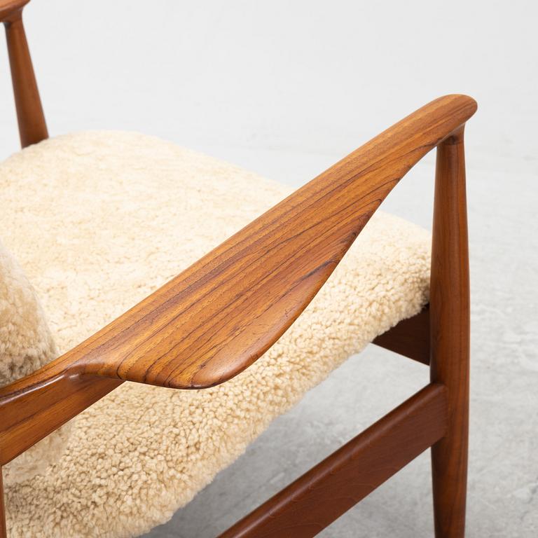 A pair of model FD 136 easy chairs with new sheepskin upholstery by Finn Juhl for France & Son, designed 1958.