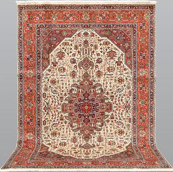 A Tabriz carpet, approximately 298 x 198 cm.