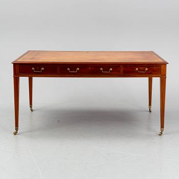 A contemporary mahogany and leather partners desk in the George III style.