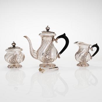 A three-piece silver coffee service, Swedish import marks. Silver sugar tongs, T.K. Alenius Vasa 1953.