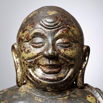 A large seated bronze figure of Budai, Ming Dynasty, dated to the fifth year of Jiajing (1526).