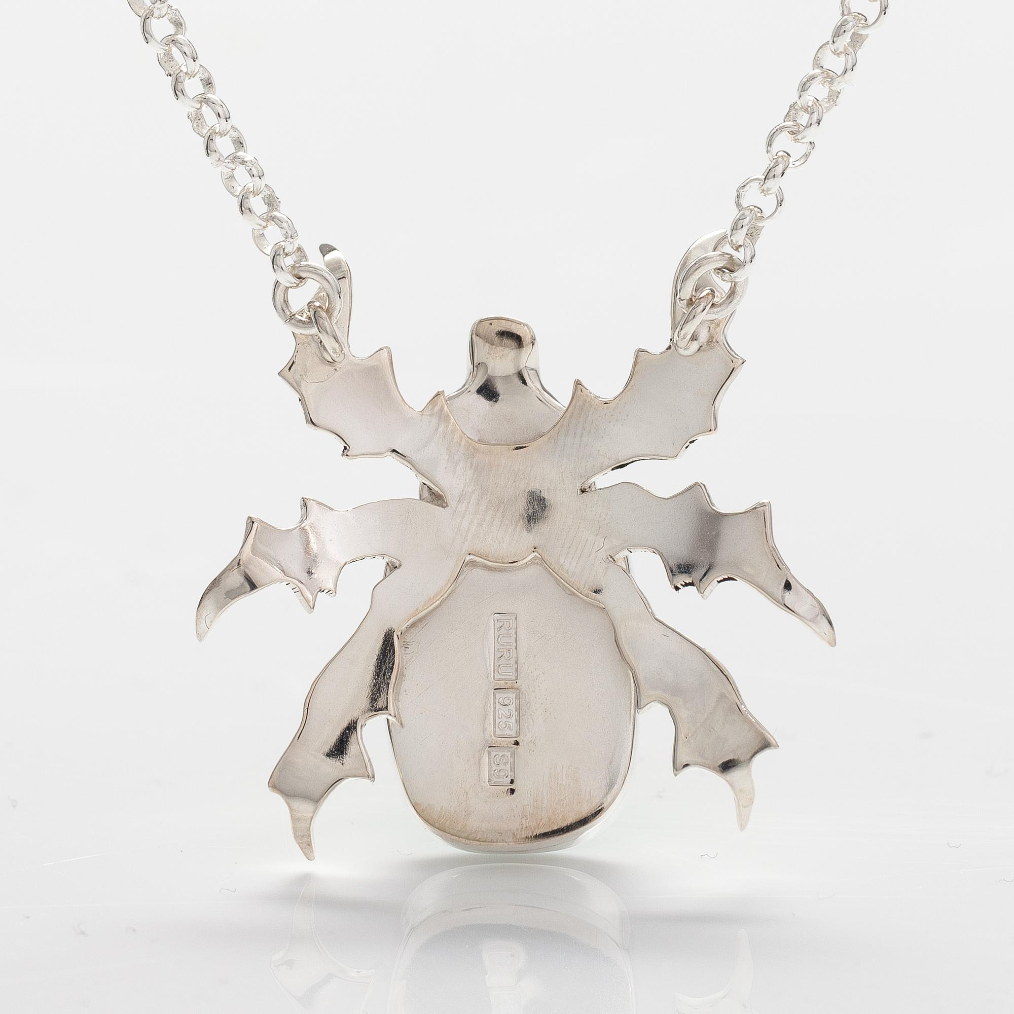 A sterling silver necklace "Gold beetle" with dichroic glass. Ru Runeberg 2019.