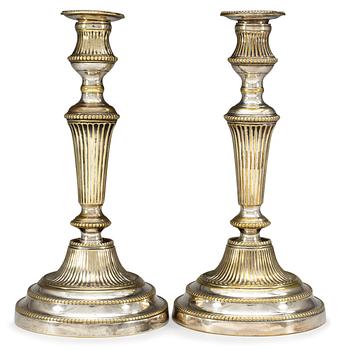 27. A pair of 19th century silvered candlesticks.
