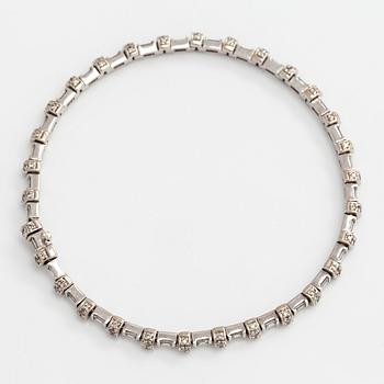 An 18K white gold bracelet set with baguette and brilliant-cut diamonds.