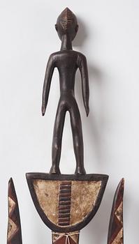 A sculptue and two masks reportedly from The Ivory coast, from the second half of the 20:th century.