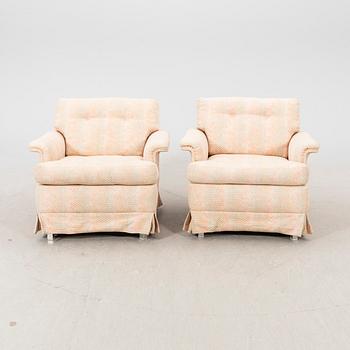 A pair of DUX 1960770s armchairs.