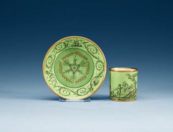 784. A green ground Sèvres cup and saucer, 18th Century.