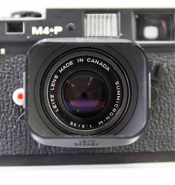 a black body Leica M4-P camera with no 1605951 made by Leitz Canada in 1982. With two lenses and a Leica Meter.