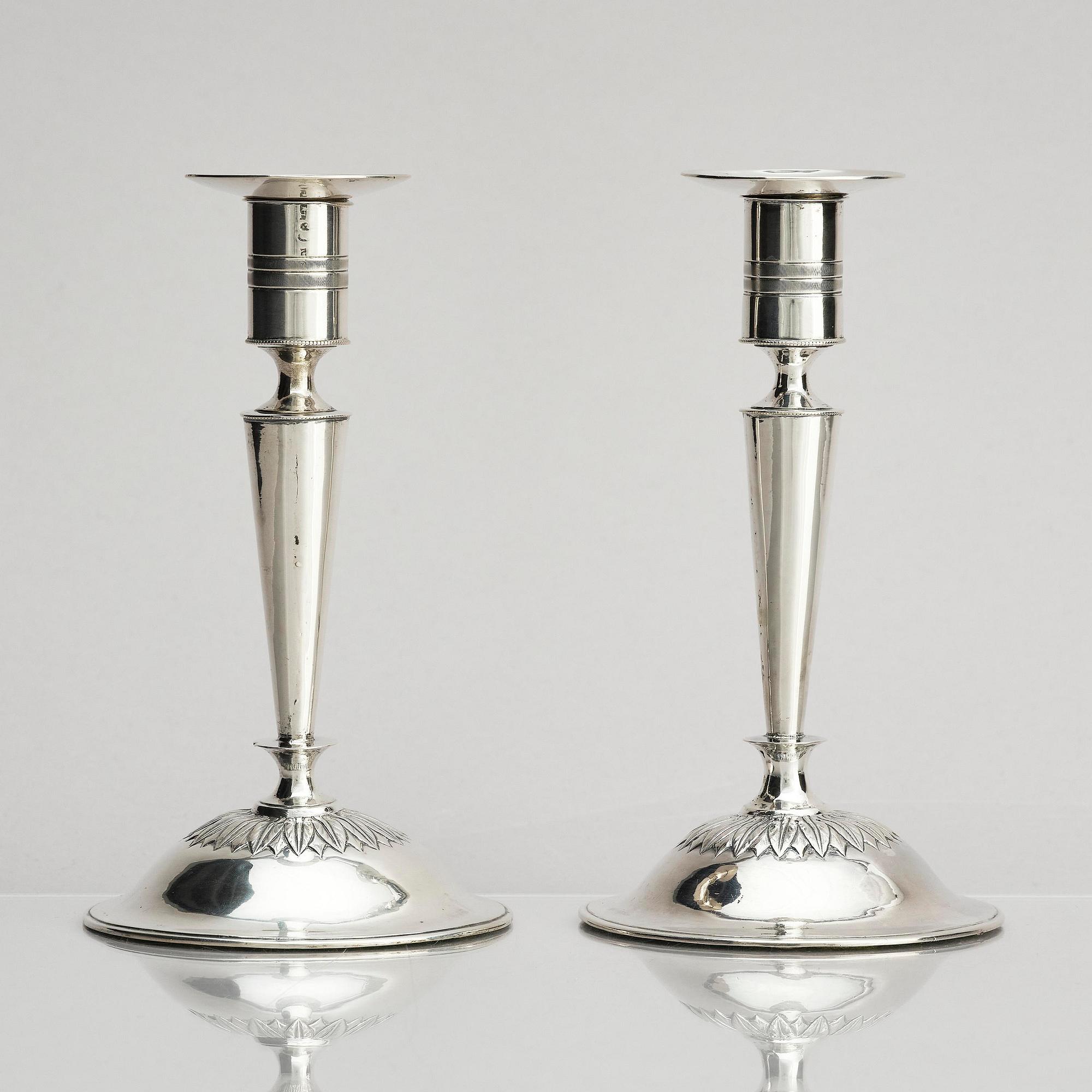 Two pair of early 19th century silver candlesticks, marks of Anders Lundqvist, Stockholm, Sweden 1819 and 1821.