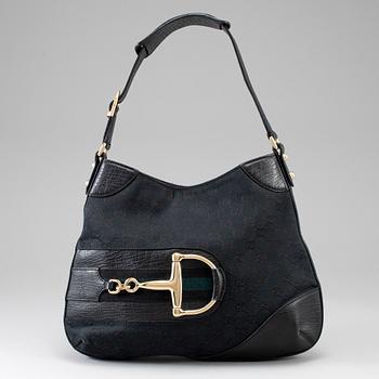 GUCCI, a black canvas and leather bag.