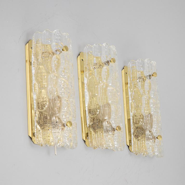 Carl Fagerlund, a set of three glass and brass wall lights, Orrefors/Nya ÖIA, second half of the 20th Century.