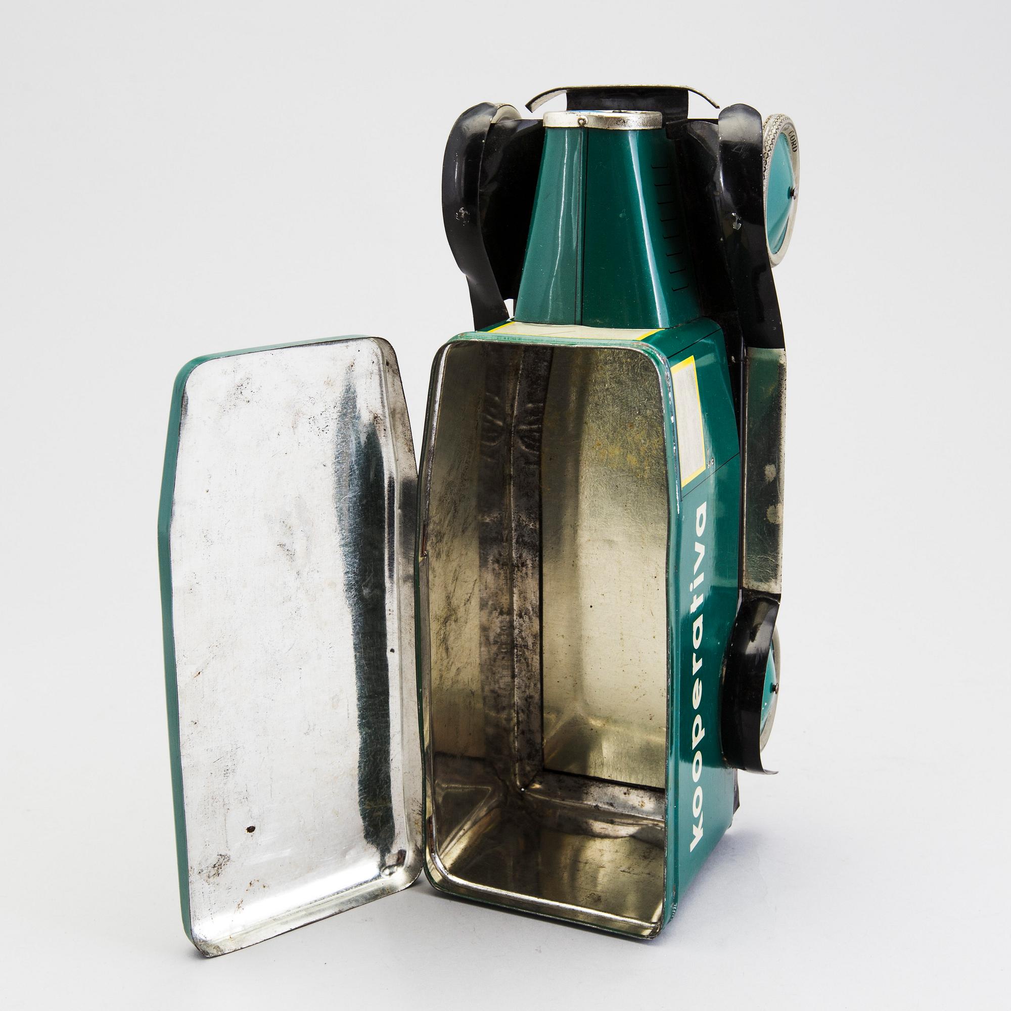 A tinplate biscuit jar in the shape of a truck 1930s.