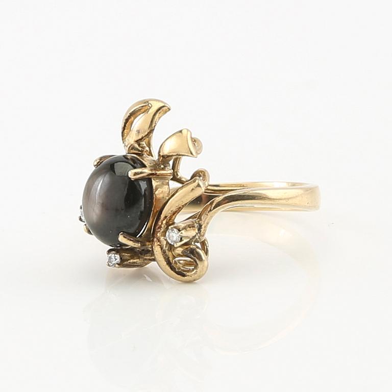 Ring and earrings in 14K gold with round brilliant-cut diamonds and likely natural black star sapphires.