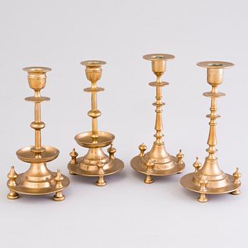 Four Russian brass candlesticks, two marked Pimenov, around 1900.