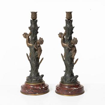 a pair of bronze and marble candle sticks, after a model by Houdon, late 19th century.