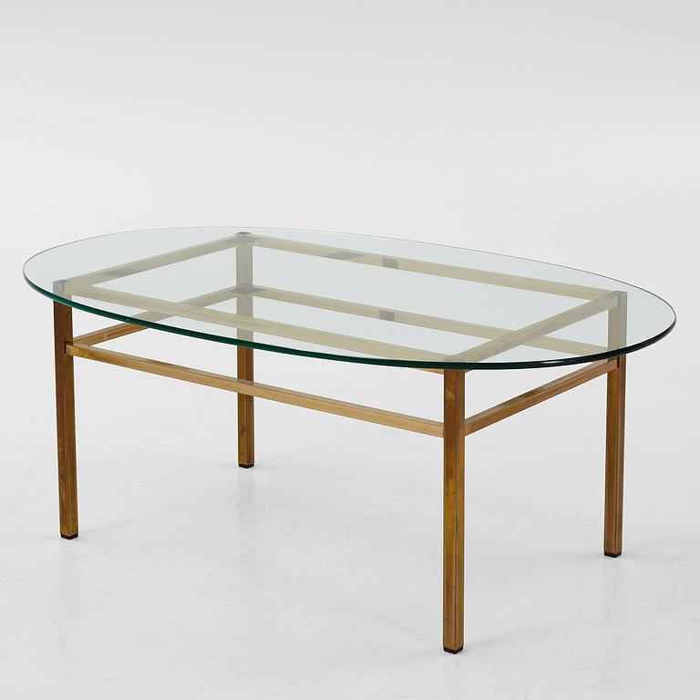 A 1970's glass and brass coffee table.