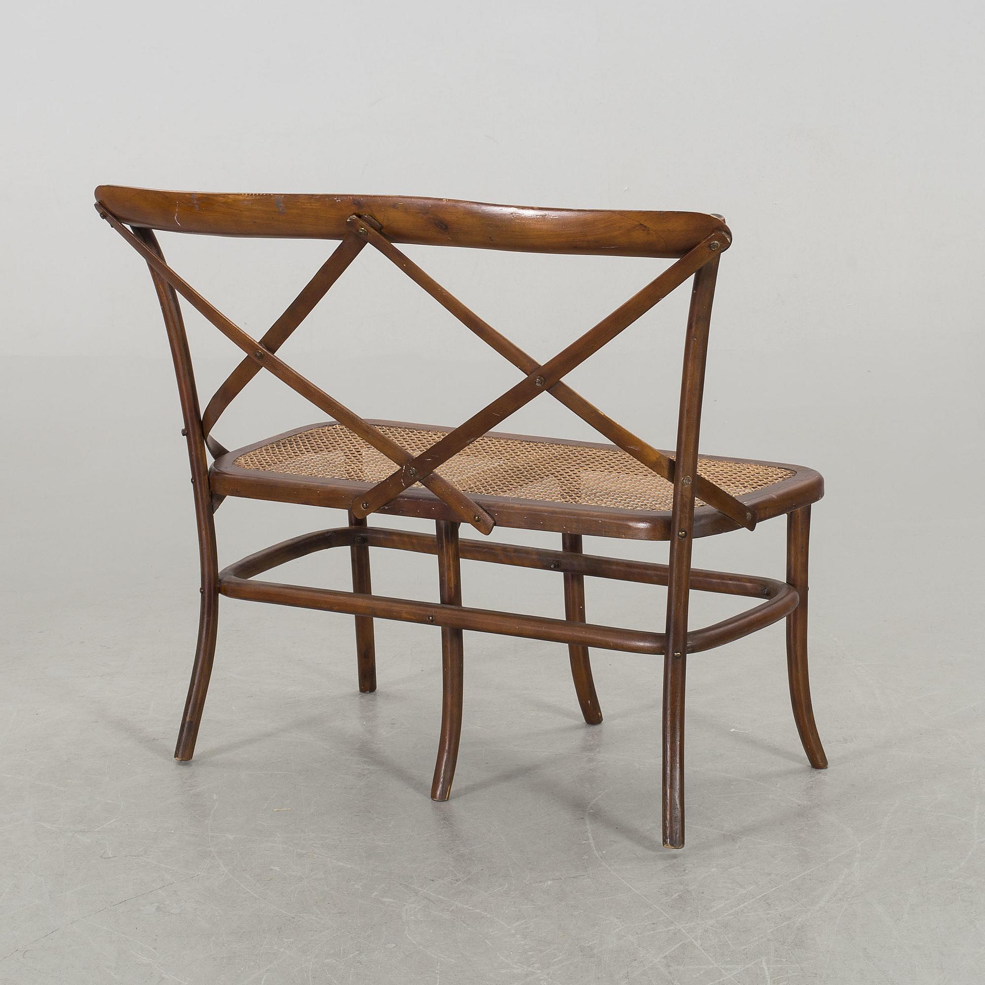 A wooden sofa, a table and four chairs, later part of the 20th century.