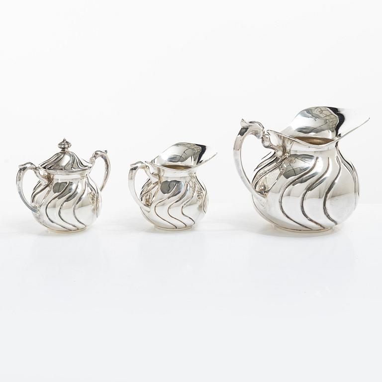 A sterling silver jug, milk jug and sugar bowl, possibly Mexico, mid20th century.