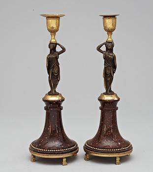 A pair of late Gustavian circa 1800 porphyry and bronze candlesticks.