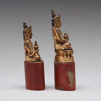 Two Sino-tibetan wooden and lacquered figures of buddha, late 19th Century.