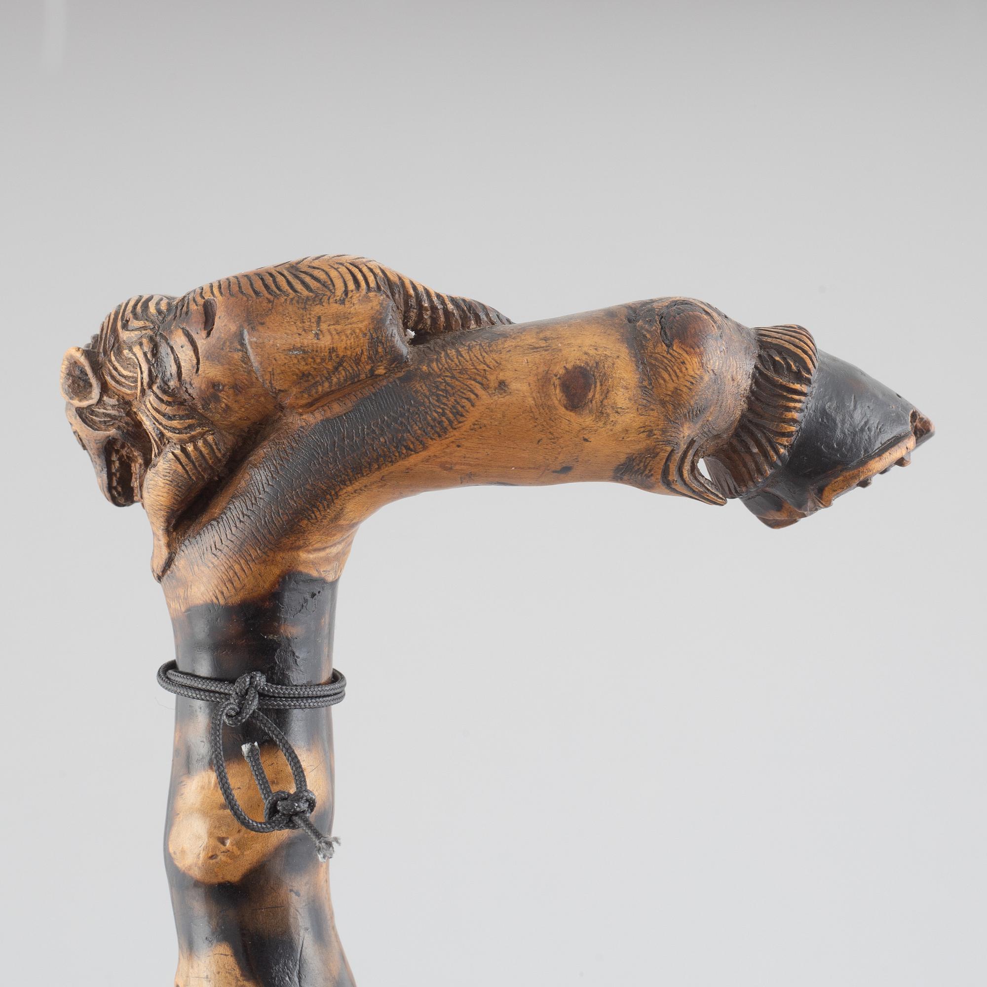 A carved wooden cane, 19th century.
