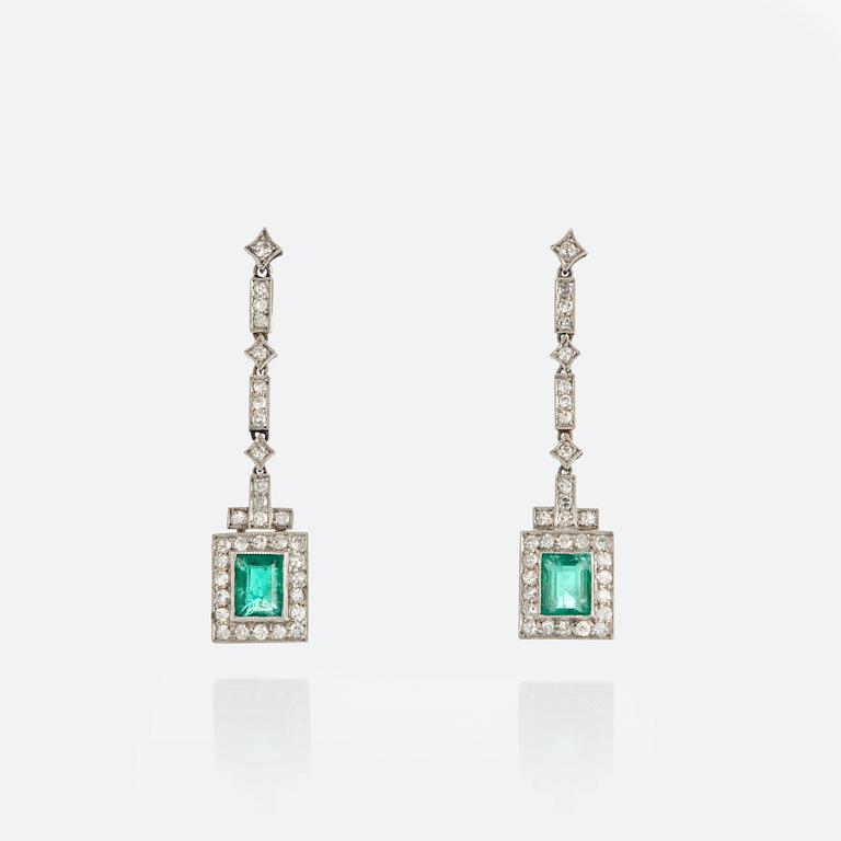 A pair of emerald earrings set with eight-cut diamonds.