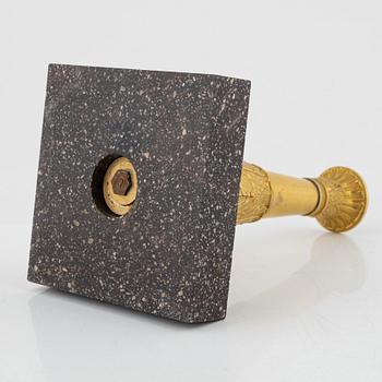 A bronze and porphyry candlestick, 20th Century.