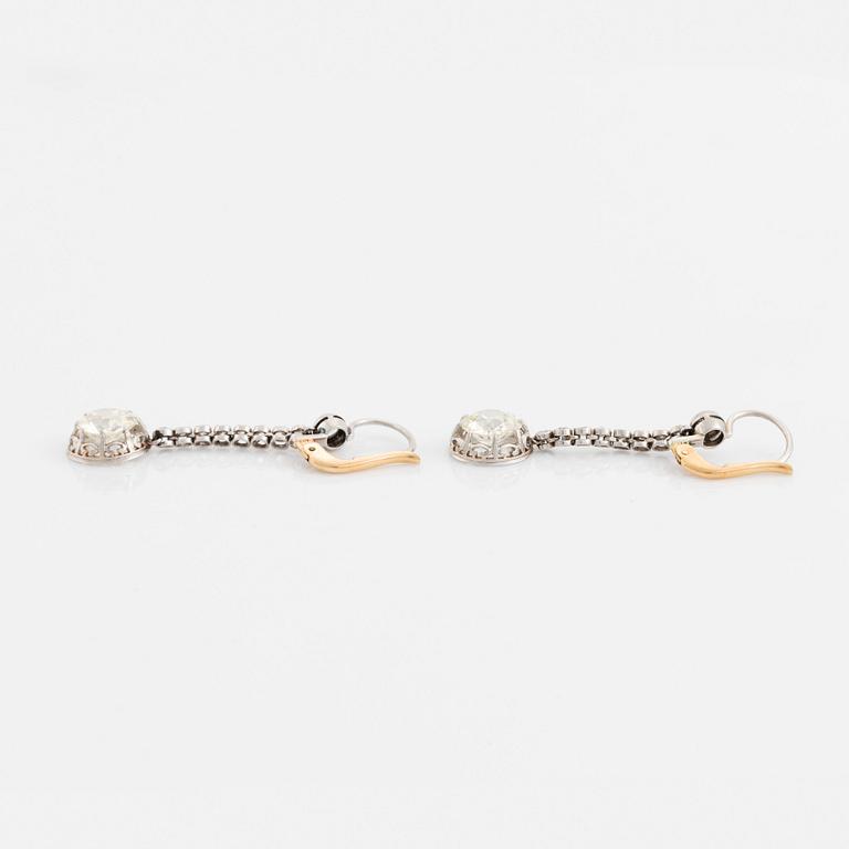 A pair of 18K white gold earrings set with old-cut diamonds.