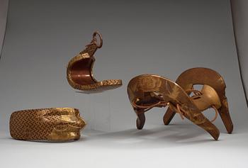 A Japanese lacquered saddle and a pair of stirrups, Meiji period (1868-1912).