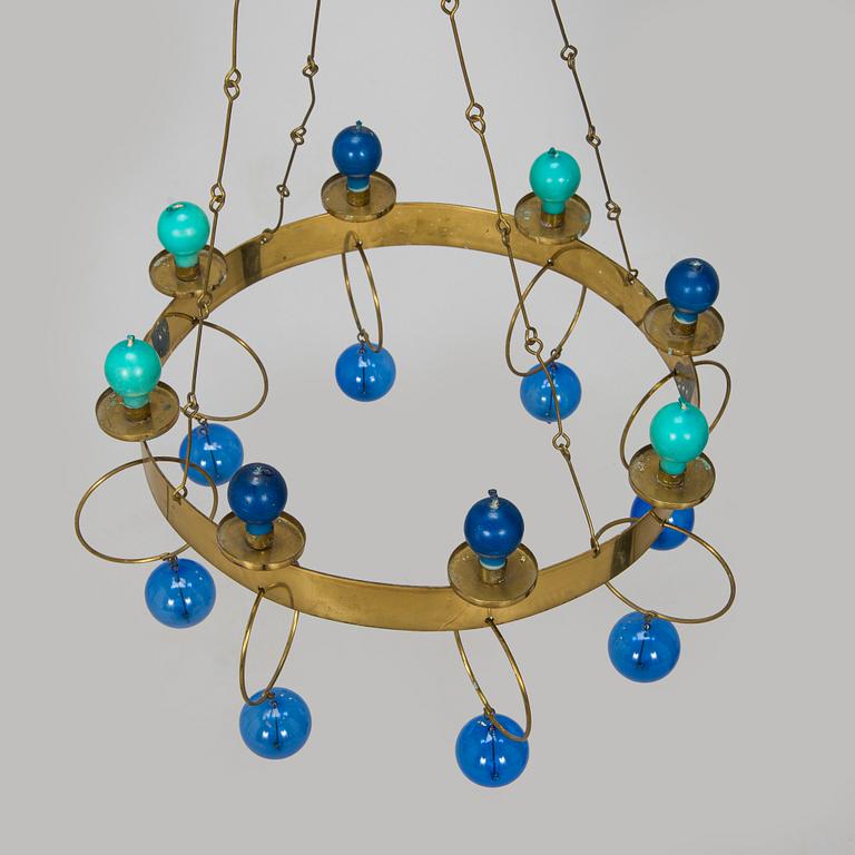 Kaija Aarikka, A 1960s/1970s brass mobile candelabra by Aarikka with candles by Timo Sarpaneva.