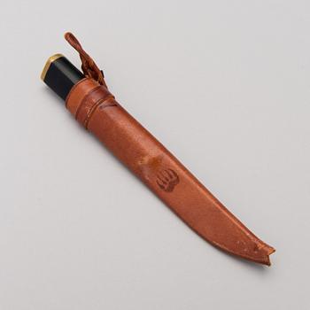 A Finnish puukko knife in stainless steel, nylon and brass designed by Tapio Wirkkala, Hackman Finland.