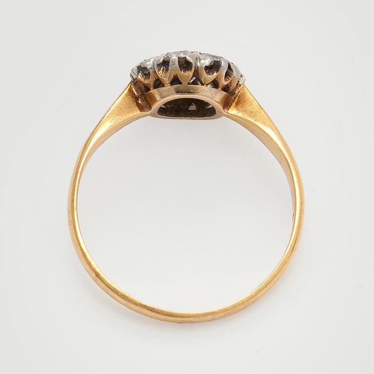 An 18K gold ring with old-cut diamonds.