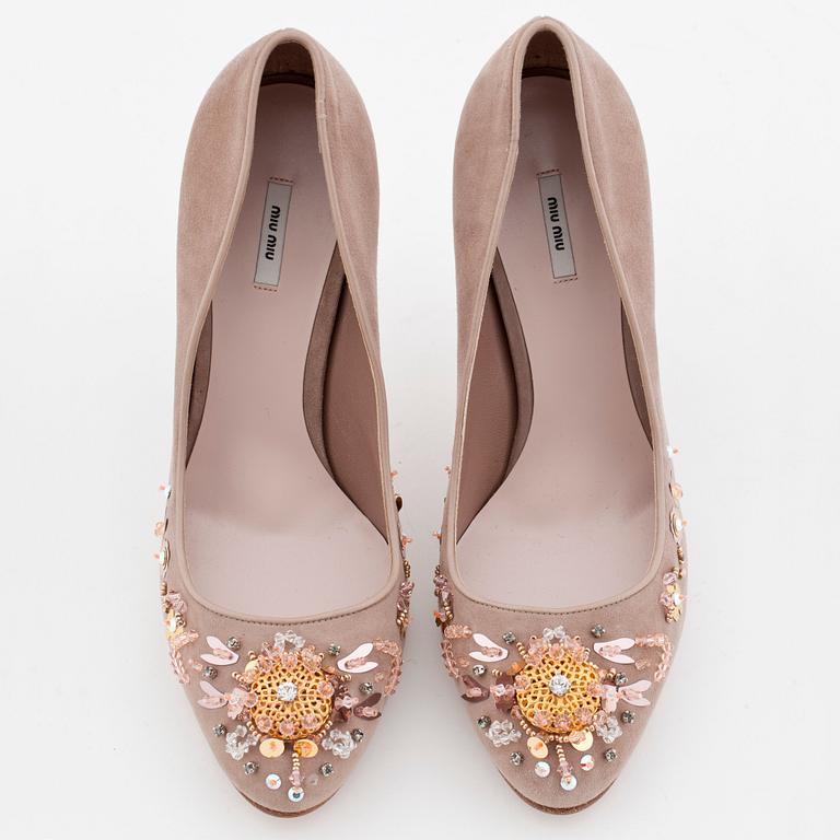 MIU MIU, a pair of beige suede pumps with sequined embellishment.