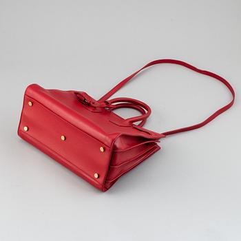 Saint Laurent, a red leather 'Sac du Jour Small' bag.