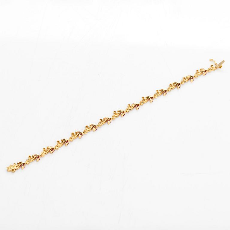 An 18K gold bracelet, with diamonds and rubies.