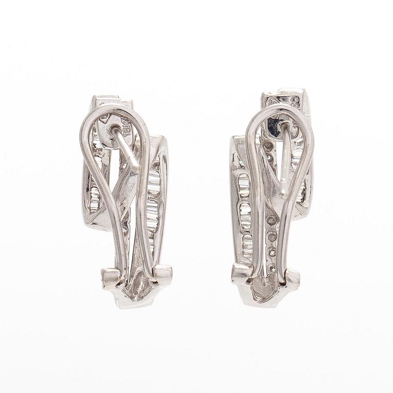 A pair of 18K white gold earrings, set with brilliant- and baguette-cut diamonds.