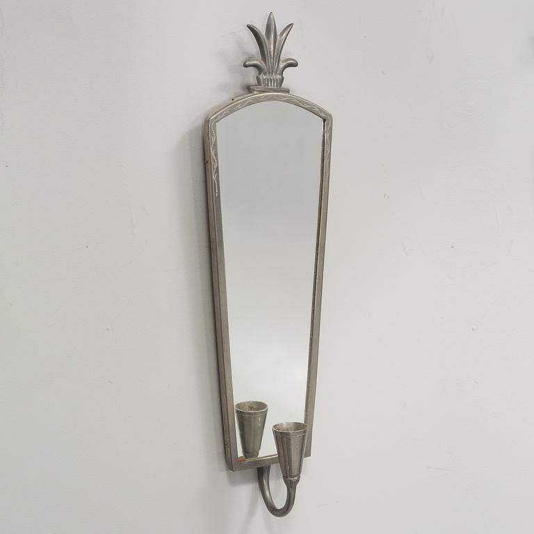 A pewter mirror and a pair of wall sconces from the first half of the 20th century.