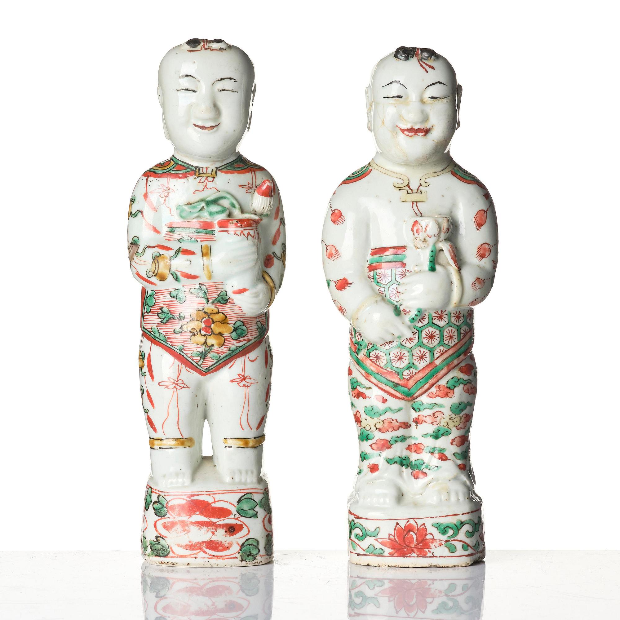 Three Chinese famille verte figures of laughing boys 'Hehe Erxian', 18th century.