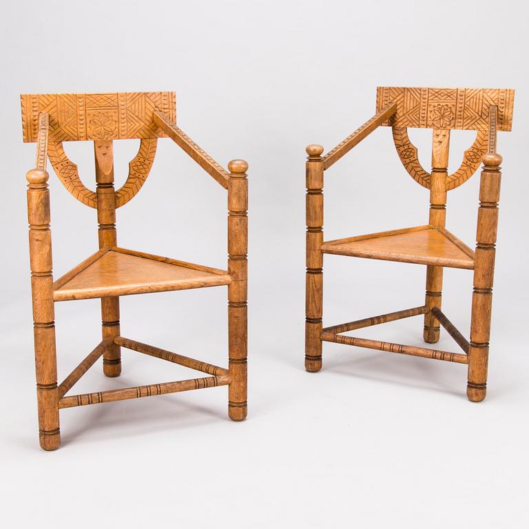 A pair of early 20th Century carved oak armchairs.