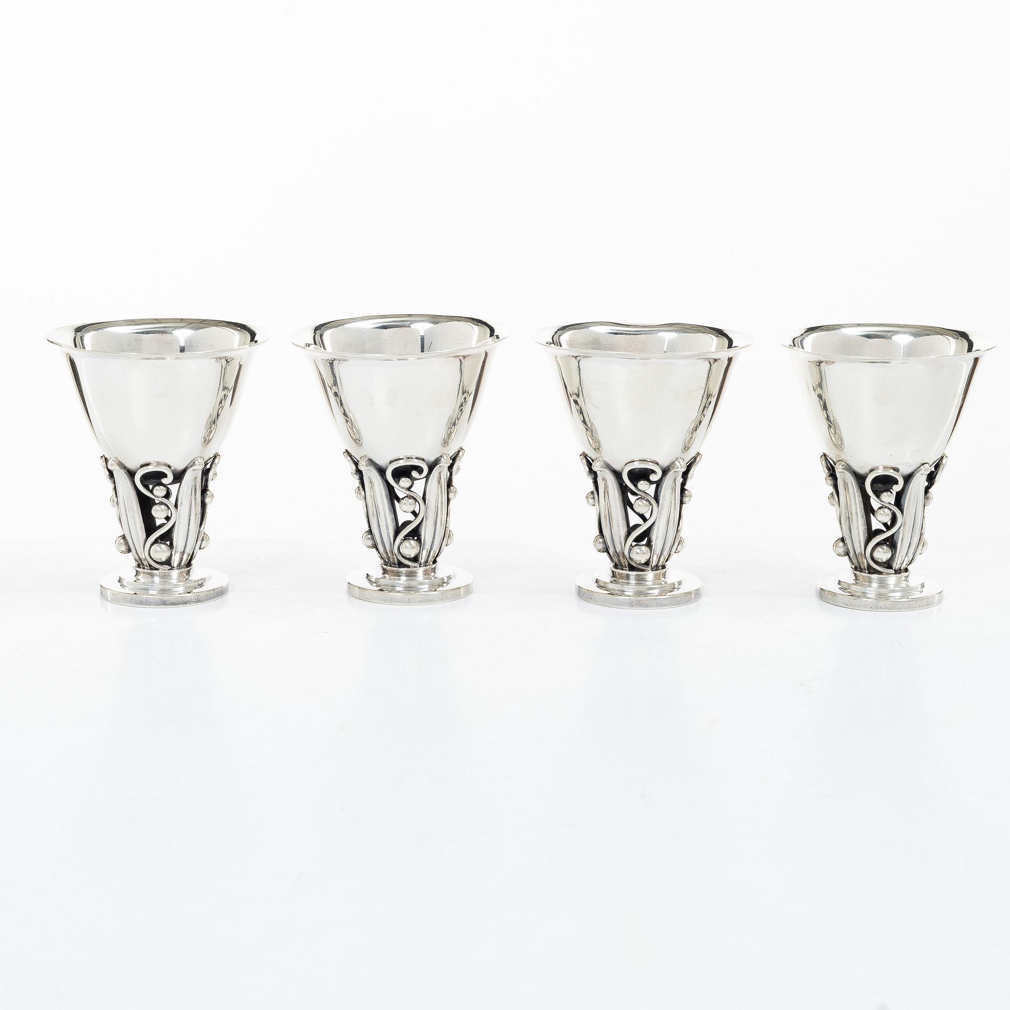 Evald Nielsen, four sterling silver beakers/cups on a foot, Denmark 20th century.