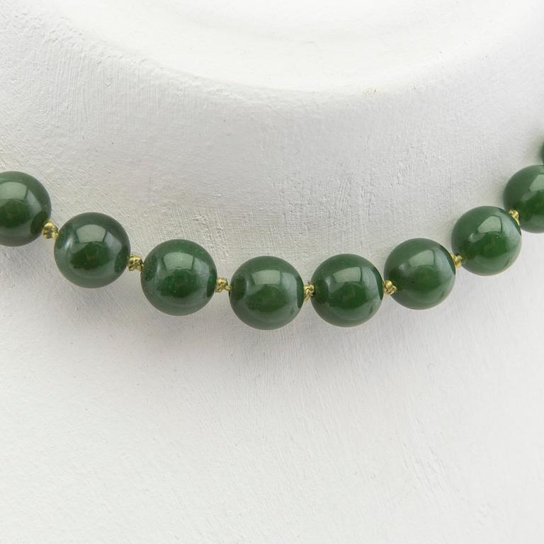 Collier, grön sten och lås i 14K guld.