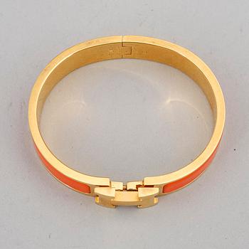 HERMÈS, a 'Clic H' bangle.