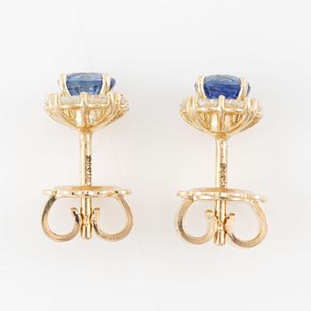 A pair of 14K gold earrings with faceted sapphires and octagon-cut diamonds.