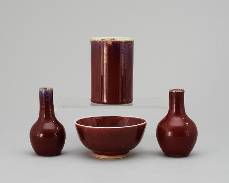 A set of one sang de boef-glazed bowl, a brush pot and two vases, Qing dynasty.