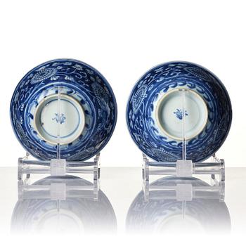 A pair of blue and white reverse decorated floral bowls, Qing dynasty, Kangxi (1662-1722).