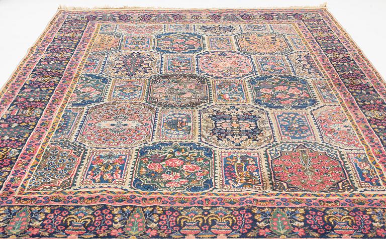 An carpet, possibly Kirman, signed, 350 x 255 cm.