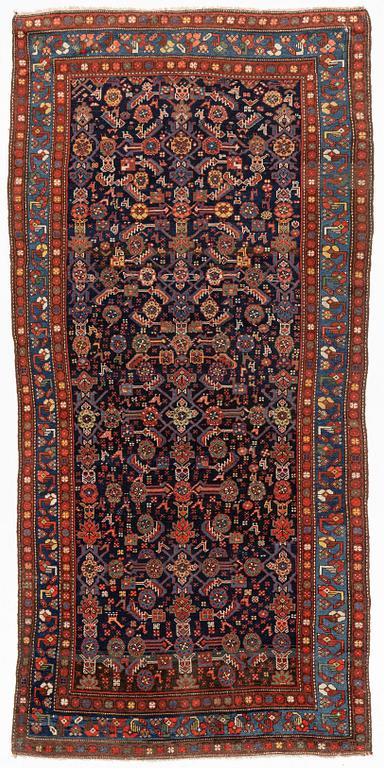 A carpet, semi-antique kurdish, circa 300 x 147 cm.