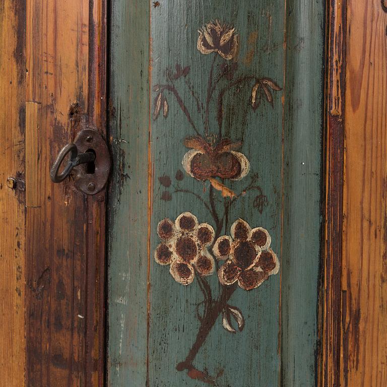 A painted folk art corner hanging cabinet, ca 1800.