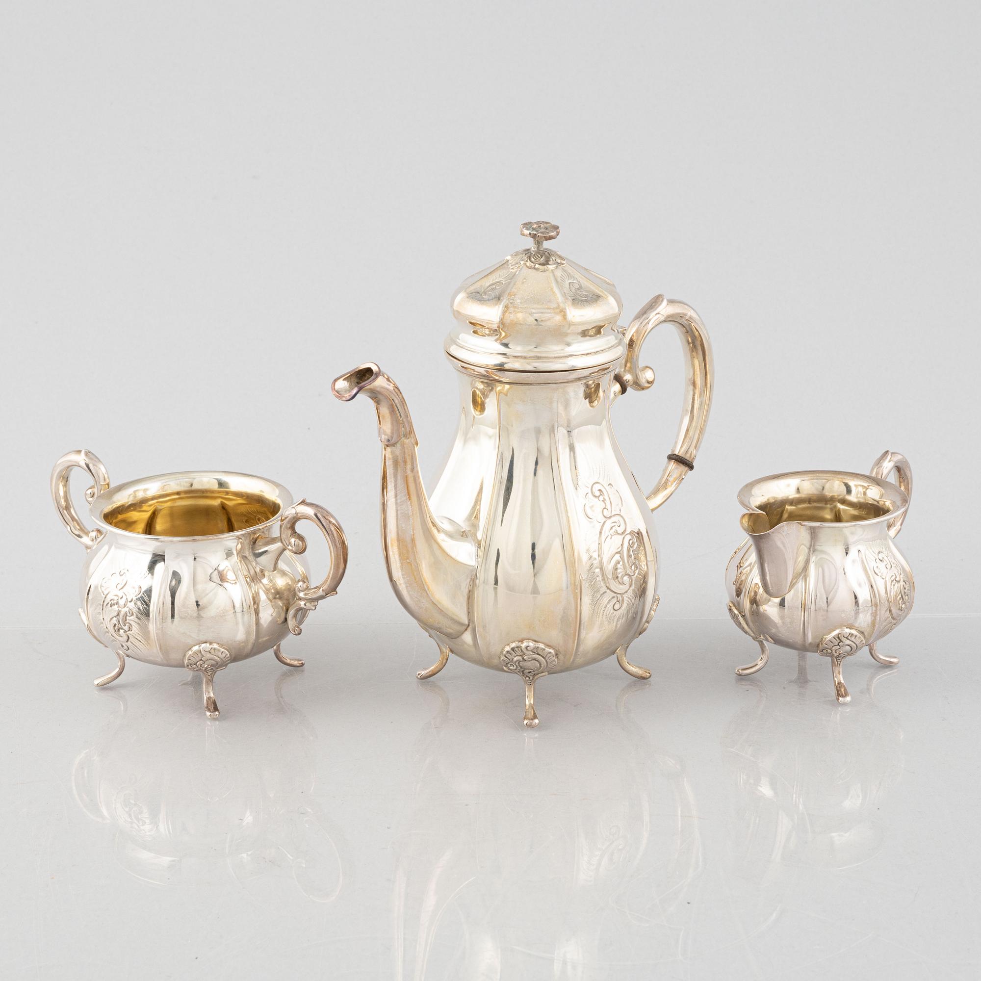 A Swedish Rococo Style Coffee Pot, Creamer and Sugar Bowl, mark of JE Skreij, Falun 1951-55.